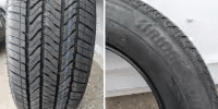Close-up view of two car tires, showcasing tread patterns and sidewall details for performance and durability assessment.