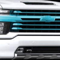 Chevrolet truck front grille featuring a distinctive turquoise accent, highlighting the modern design elements and branding of the vehicle.