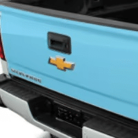 Chevrolet truck front grille featuring a distinctive turquoise accent, highlighting the modern design elements and branding of the vehicle.