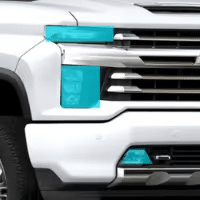 Chevrolet truck front grille featuring a distinctive turquoise accent, highlighting the modern design elements and branding of the vehicle.